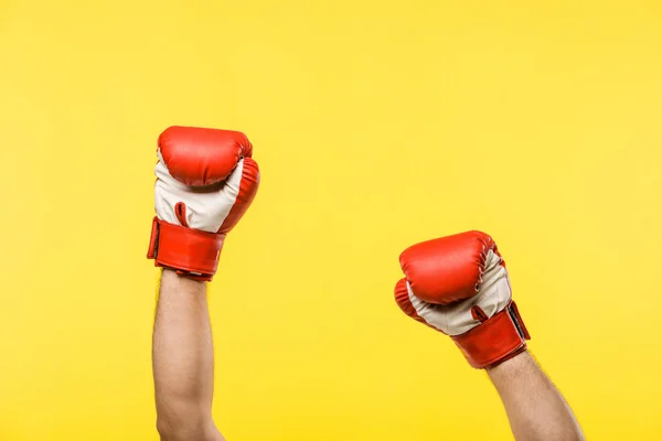 Cropped shot of person in boxing gloves isolated on yellow — Stock Photo