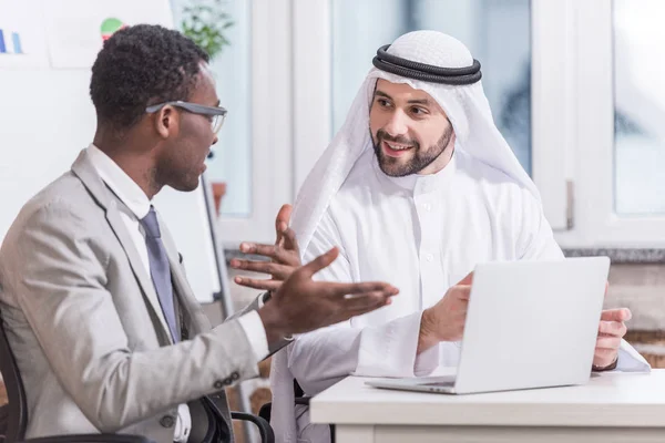 Multiethnic businessmen having discussion in modern office — Stock Photo