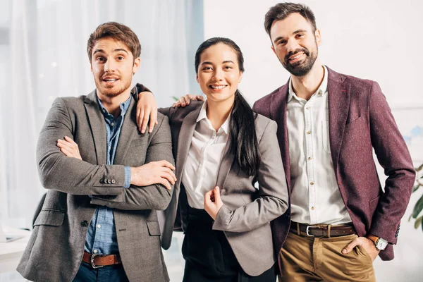 Happy office managers looking at camera and smiling in office — Stock Photo