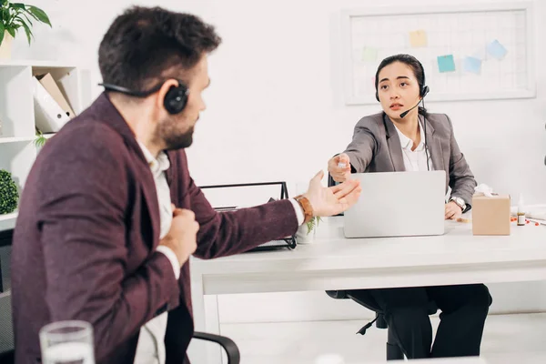 Call center operator giving medicine to coworker in office — Stock Photo