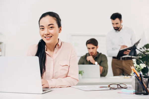 Selective focus of female manager sitting in modern office — Stock Photo