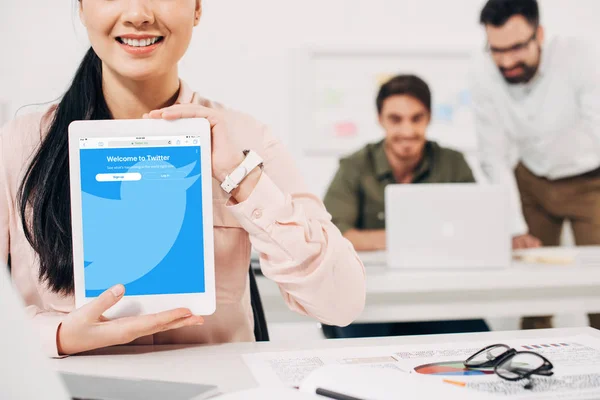 Cropped view of woman showing digital tablet with twitter app — Stock Photo