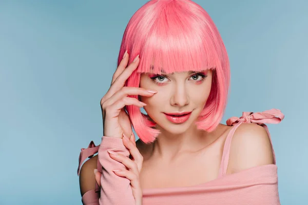 Attraktive modische Mädchen posieren in rosa Perücke isoliert auf blau — Stockfoto