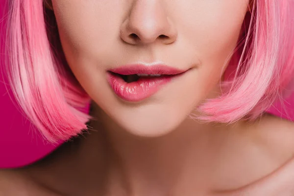 Cropped view of sensual girl biting lip on pink — Stock Photo