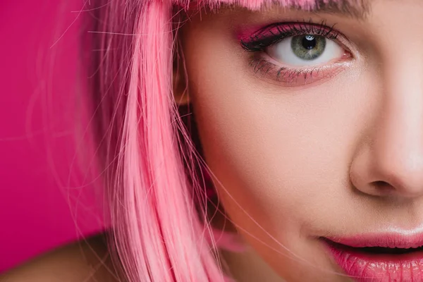 Primer plano de hermosa chica posando en peluca rosa, aislado en rosa - foto de stock