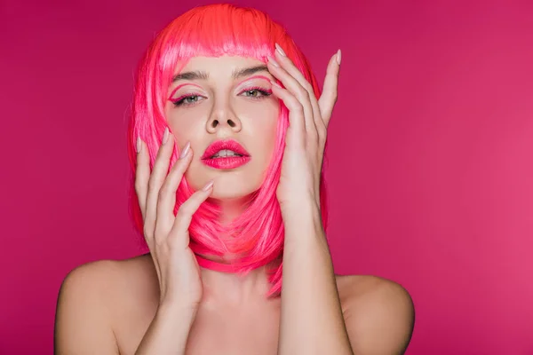 Beautiful naked girl posing in neon pink wig, isolated on pink — Stock Photo