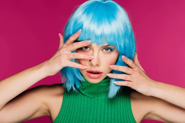 Beautiful young woman gesturing and posing in blue wig, isolated on pink — Stock Photo