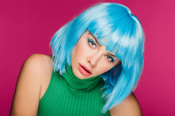 Beautiful stylish girl posing in blue wig, isolated on pink — Stock Photo