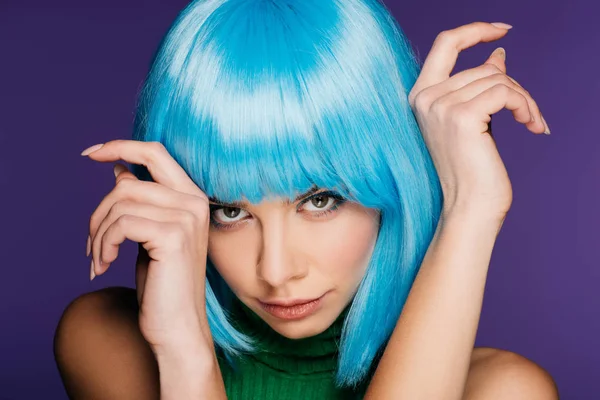 Beautiful girl posing in blue wig, isolated on purple — Stock Photo