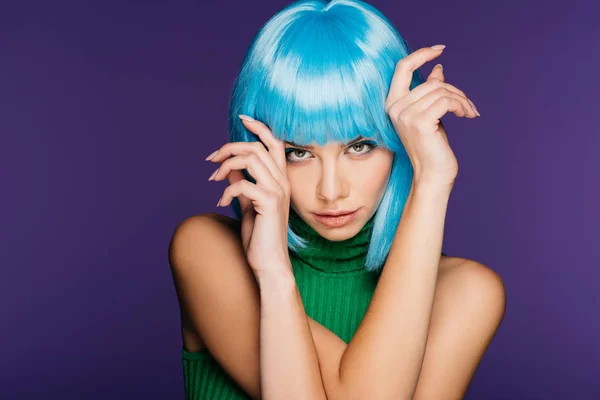 Attractive girl gesturing and posing in blue wig, isolated on purple — Stock Photo