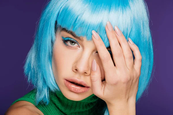 Bela menina encantadora posando em peruca azul, isolado em roxo — Fotografia de Stock