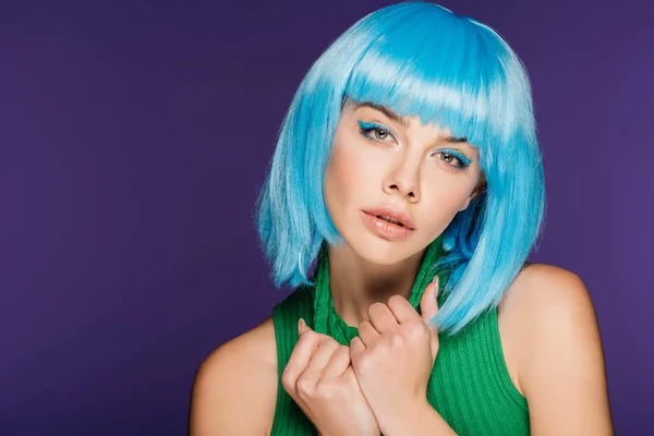 Glamor young woman posing in blue wig and green turtleneck, isolated on purple — Stock Photo