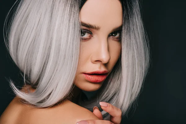 Stylish young woman posing in grey wig, isolated on black — Stock Photo