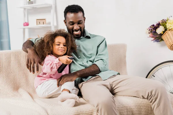 Afro-americano homem e filha assistindo TV juntos na sala de estar — Fotografia de Stock