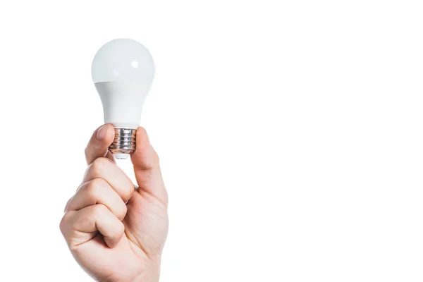 Vista recortada del hombre sosteniendo lámpara fluorescente aislada en blanco, concepto de eficiencia energética - foto de stock