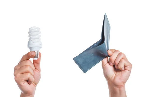Vista recortada de manos masculinas sosteniendo lámpara fluorescente y billetera en manos aisladas en blanco, concepto de eficiencia energética - foto de stock