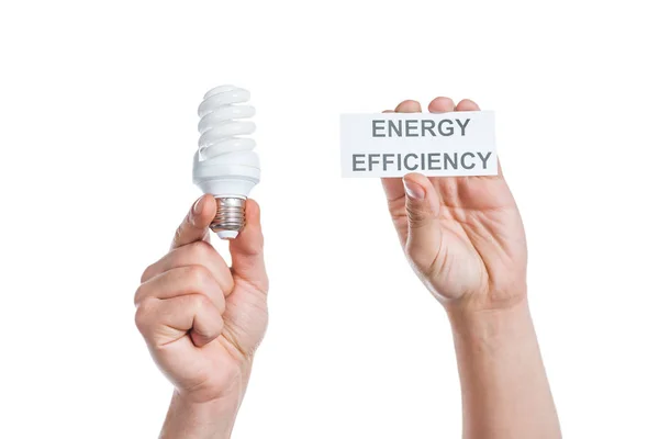 Cropped view of male hands holding paper card with lettering and fluorescent lamp isolated on white, energy efficiency concept — Stock Photo