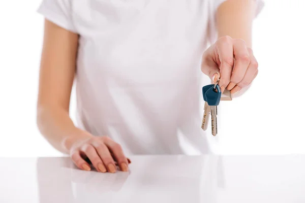 Selective focus of woman holding keys isolated on white, mortgage concept — Stock Photo