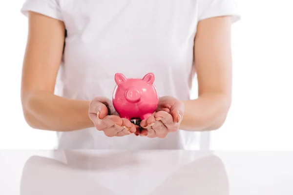 Cropped view of woman holding pink piggy bank isolated on white — Stock Photo