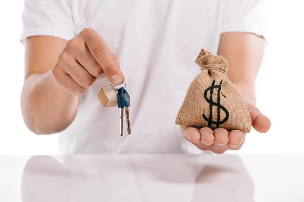 Cropped view of man holding keys and moneybag isolated on white, mortgage concept — Stock Photo