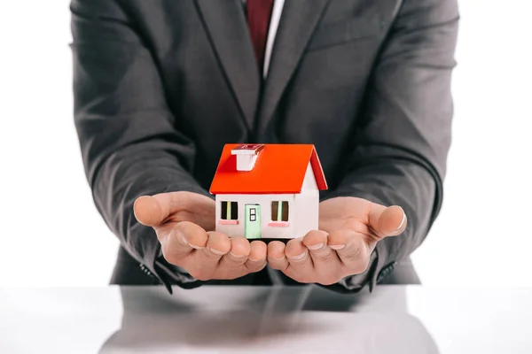 Cropped view of mortgage broker holding house model isolated on white — Stock Photo