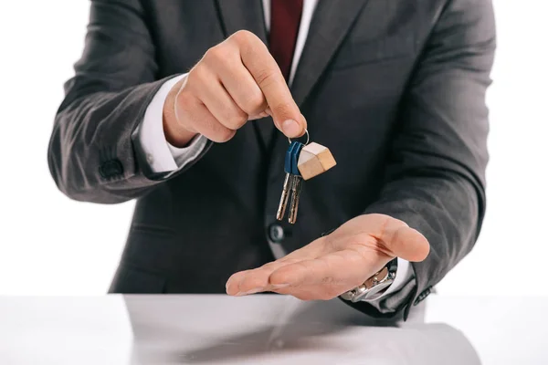 Partial view of mortgage broker holding keys isolated on white — Stock Photo