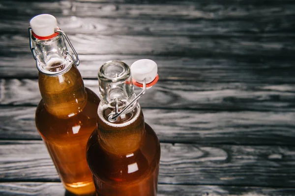 Fermented tea in glass bottles on wooden table — Stock Photo