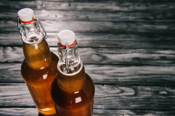 Studio shot of fermented tea in glass bottles with sunlight — Stock Photo