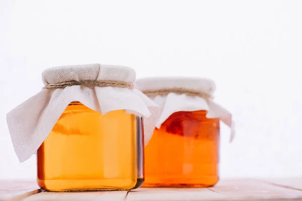 Selective focus of bottled natural kombucha mushroom with tea in jars isolated on white — Stock Photo