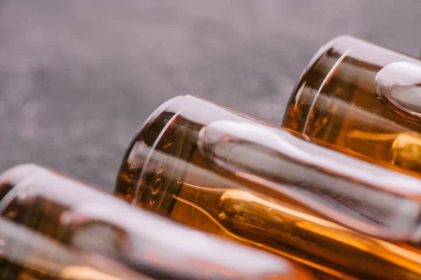 Close up of bottles with cbd oil on grey background — Stock Photo