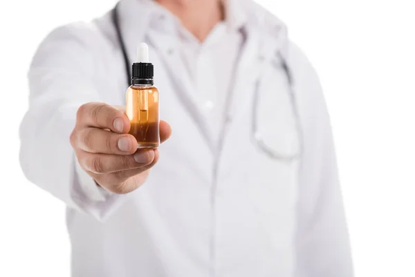 Cropped view of male doctor holding bottle with cbd oil in hand isolated on white — Stock Photo