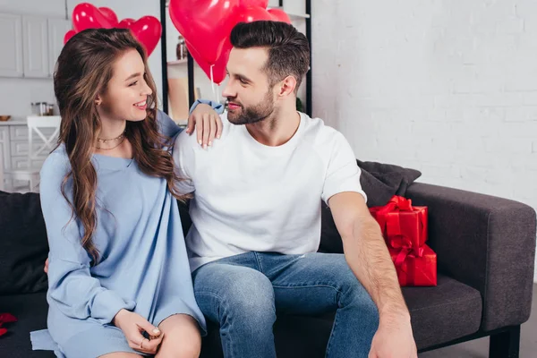 Happy couple celebrating st valentine day while young woman embracing man — Stock Photo