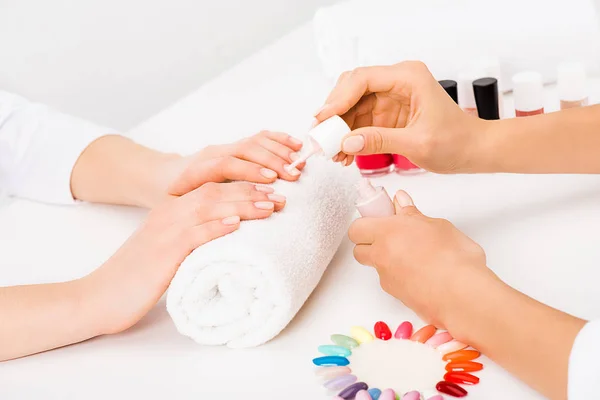 Partial shot of manicurist applying nail polish — Stock Photo