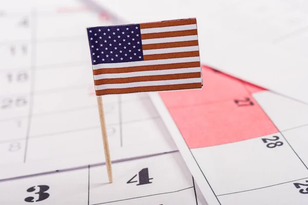 Selective focus of american flag marking number 4 on calendar — Stock Photo