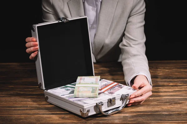 Cropped shot of businesswoman holding suitcase safe box with russian rubles banknotes — Stock Photo