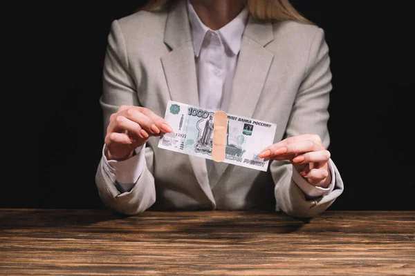 Cropped shot of businesswoman holding russian rubles banknote with medical patch — Stock Photo