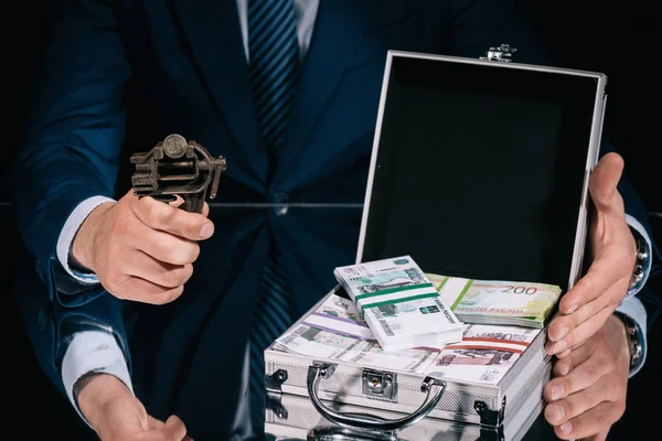 Cropped shot of businessman holding iron vise tool with russian ruble coin and suitcase safe box with banknotes — Stock Photo