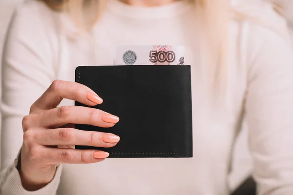 Close-up partial view of woman holding wallet with russian rubles banknotes — Stock Photo