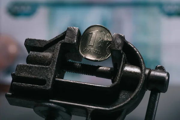 Close-up view of iron vise tool with one ruble coin, selective focus — Stock Photo