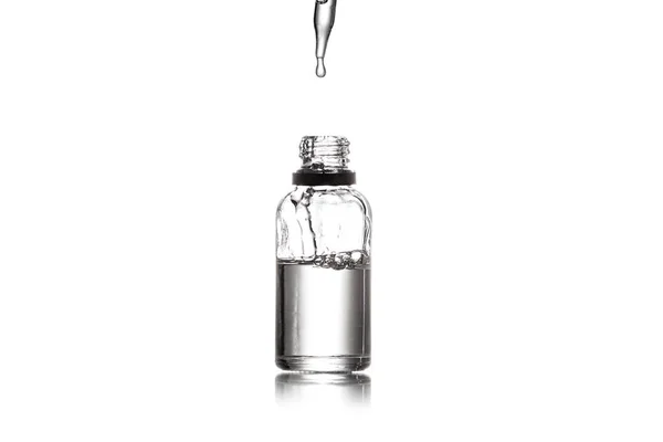 Studio shot of serum bottle with pipette isolated on white — Stock Photo