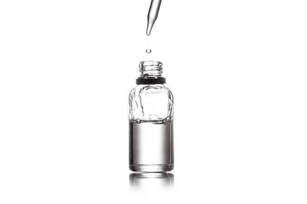 Studio shot of serum bottle and dropper isolated on white — Stock Photo