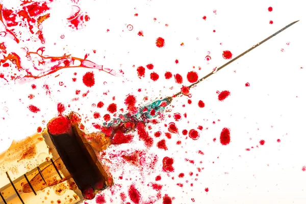 Close up view of syringe and blood on white — Stock Photo