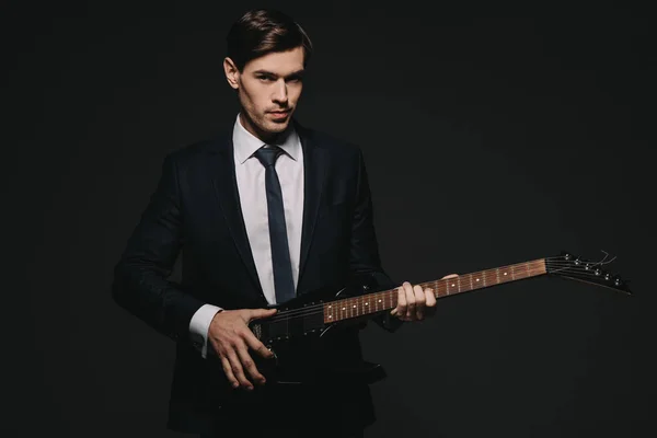Schöner Geschäftsmann mit elektronischer Gitarre isoliert auf schwarz — Stockfoto