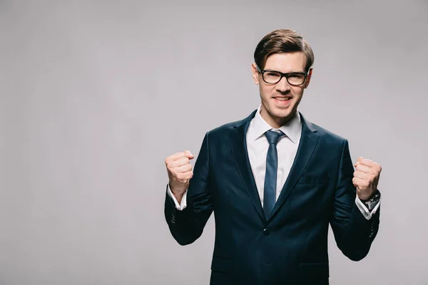 Excited businessman celebrating victory isolated on grey — Stock Photo