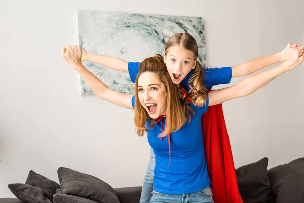 Cheerful mother and daughter playing at home — Stock Photo