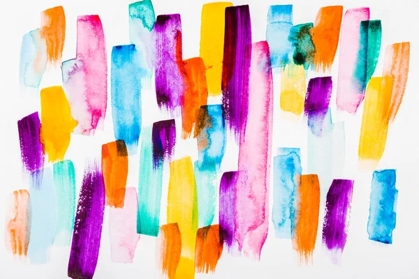 Top view of pink, purple, yellow, blue and orange brushstrokes on white background — Stock Photo