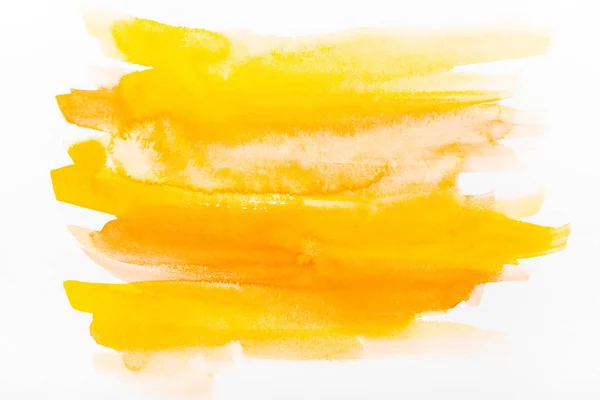 Top view of yellow watercolor brushstrokes on white paper — Stock Photo