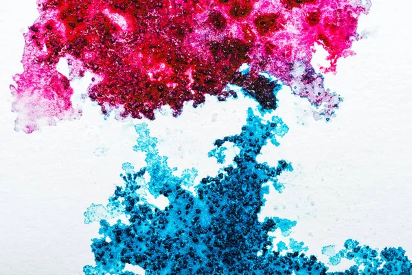 Top view of blue and pink watercolor spills on white paper — Stock Photo