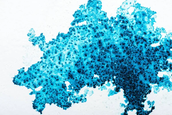 Top view of blue watercolor spill on white paper with copy space — Stock Photo