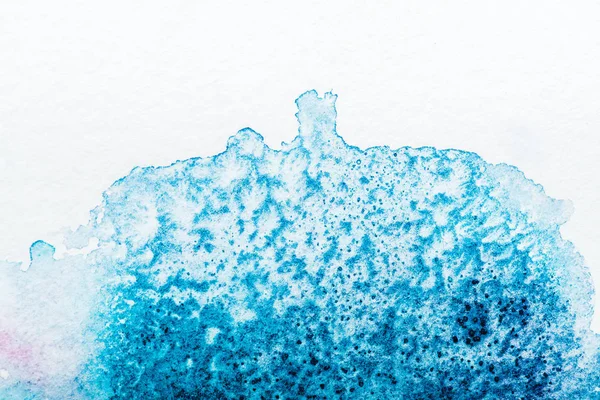 Vista superior do derramamento de aquarela azul no papel branco — Fotografia de Stock